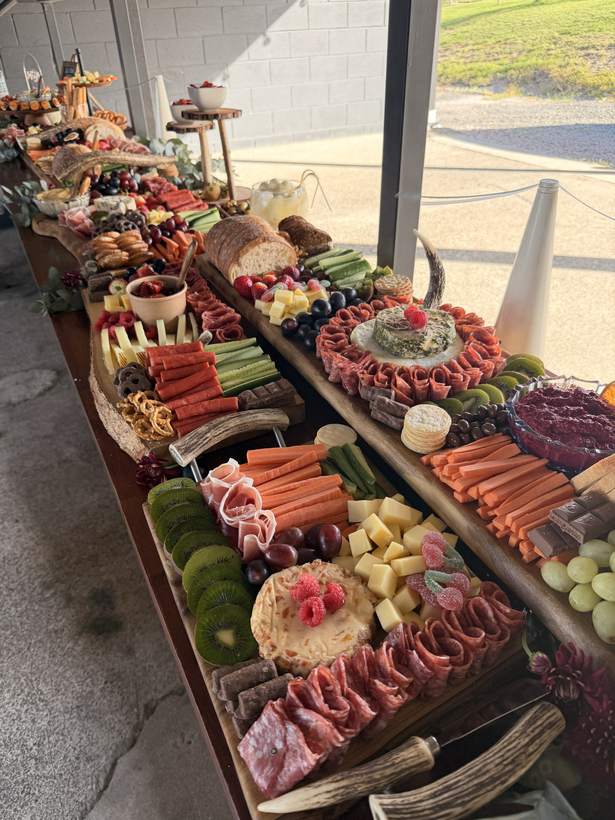 A very long grazing table running down a covered venue