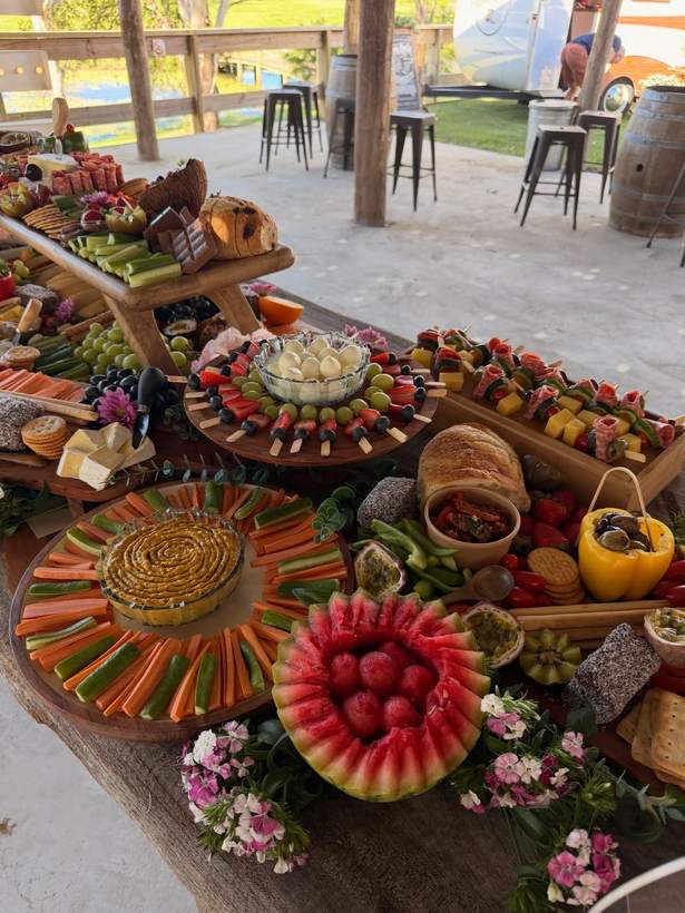 Watermelon, carrot platters and fruit skewers on round boards